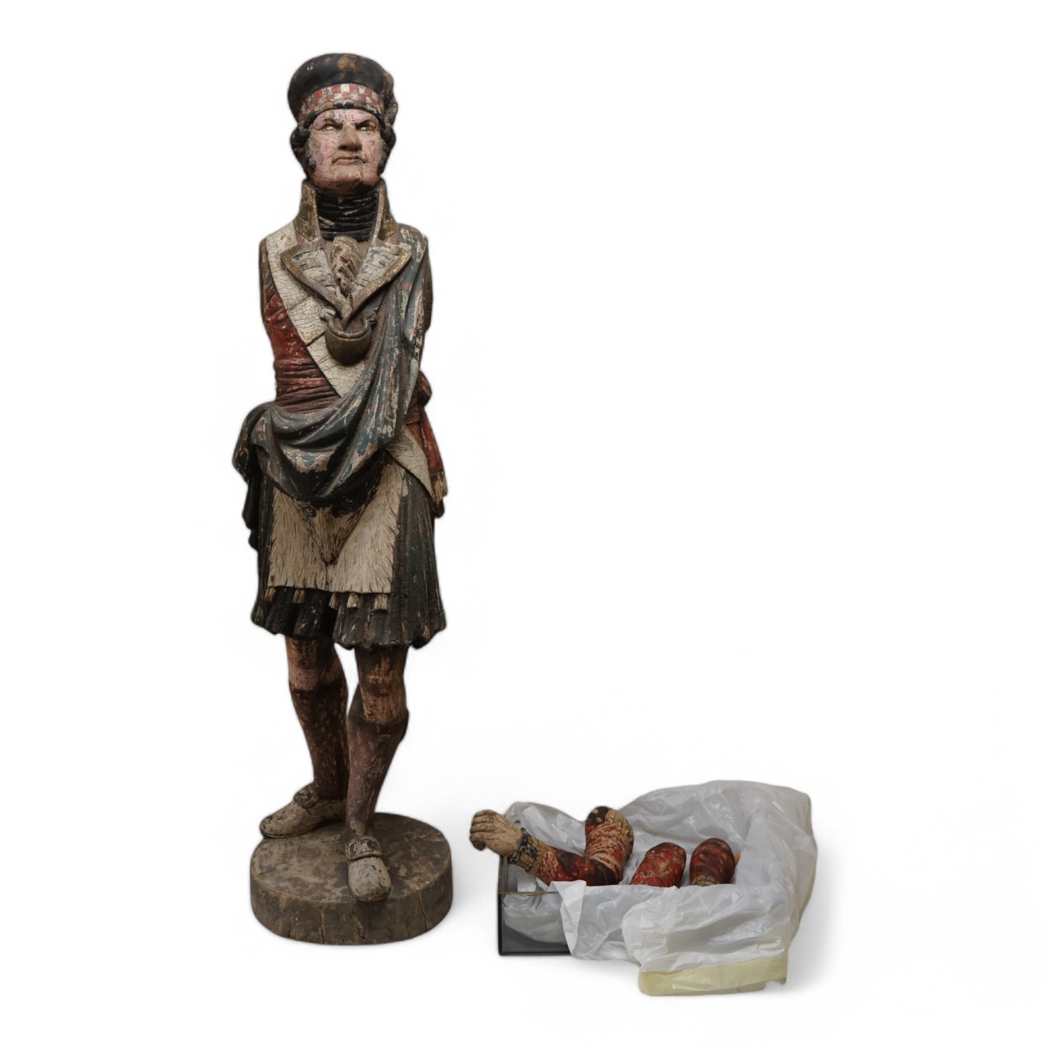 A large 19th century carved and painted Highlander ‘Snuff’ shop advertising figure. 109cm high. Condition - paint work and base weathered, arms detached.